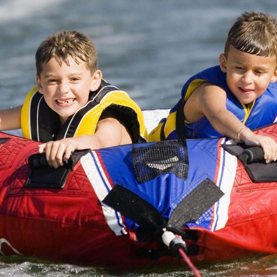 two-kids-tubing-on-the-water-550x550